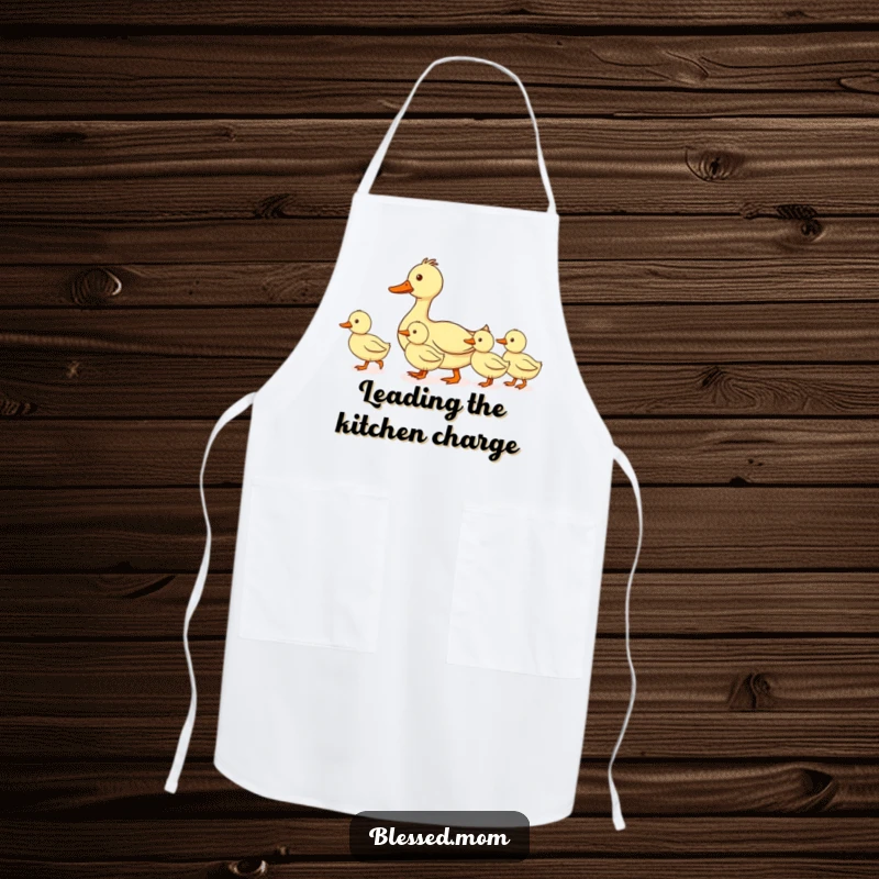 Funny mom duck apron, showing a mother duck leading her ducklings in a perfectly straight line, ideal for cooks who appreciate organization and humor.