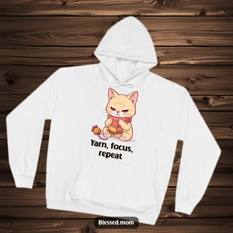Cozy cat knitting hoodie featuring a focused cat crafting a vibrant scarf, a humorous and warm gift for crafters.