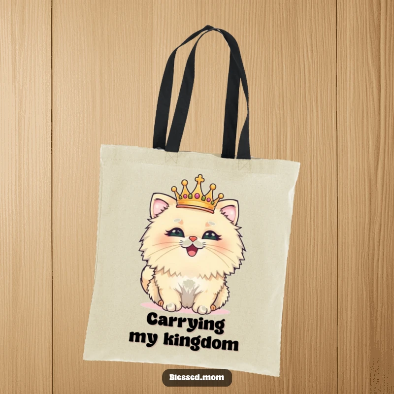 Funny tote bag depicting a fluffy cat wearing a tiny crown, beaming with pride, perfect for carrying everyday items with humor.